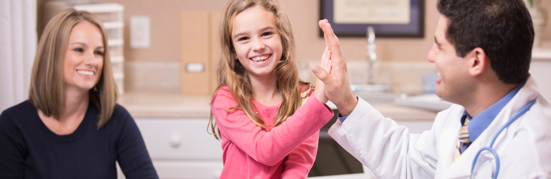 child high fiving clinician